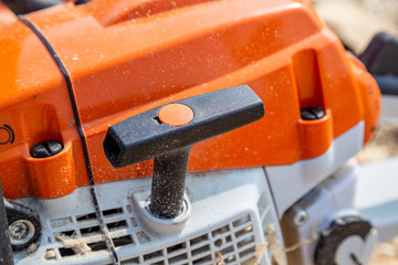 Chainsaw for a tree. Sawing firewood outdoors.