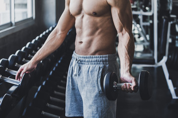 Fototapeta na wymiar Fitness man doing exercise in gym