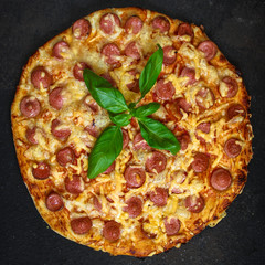 pizza with sausages (tomato sauce, cheese, meat). food background. top view. copy space
