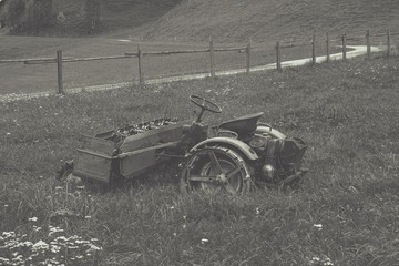 Fototapeta na wymiar a old hay mower in a meadow