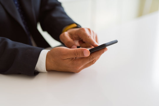 Close up of business man hands using smarpthone