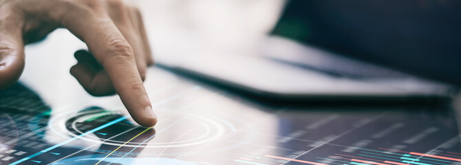 Businessman is analysing financial strategy on a screen of modern hi tech digital tablet. Male...