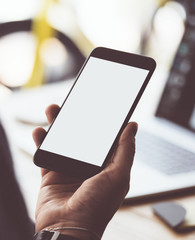 Close up of male hands with smartphone. Blank screen, Mock-up, copyspace ready for text or design