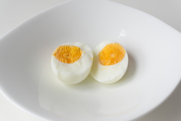 Sliced boiled eggs on white plate, Ready to eat.