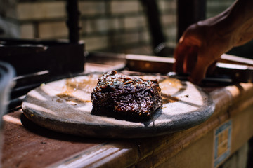 A medium rare beef stake laying on the table