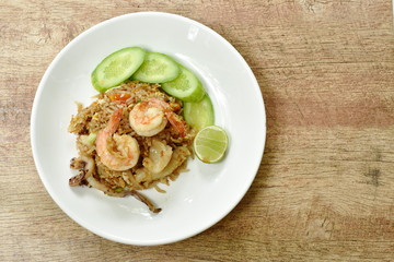 fried rice shrimp and squid with slice cucumber on plate