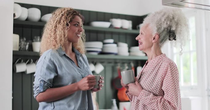 Senior adult woman having coffee with daughter