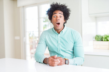 African American business man wearing elegant shirt afraid and shocked with surprise expression, fear and excited face.
