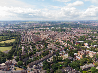 Aerial photo over looking the area of Leeds known as Headingley in West Yorkshire UK, showing a typical British hosing estate with fields and roads taken with a drone on a sunny day
