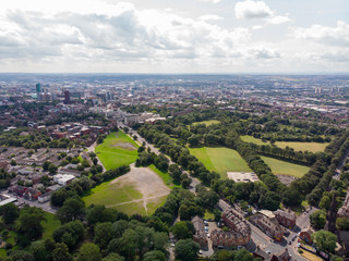 Obraz premium Aerial photo over looking the area of Leeds known as Headingley in West Yorkshire UK, showing a typical British hosing estate with fields and roads taken with a drone on a sunny day