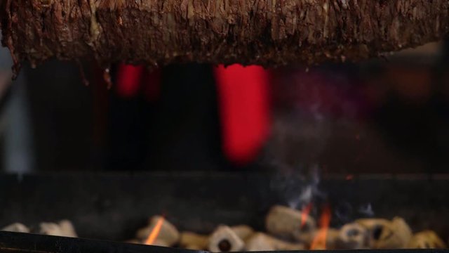 Fire and ht coals below a Doner kebab