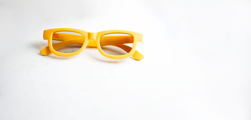 Close-up of yellow glasses isolated on white background.
