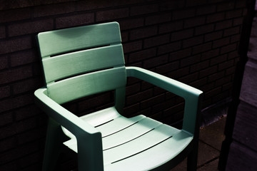 Abstract image on green chair in shadows