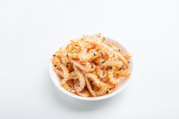 A plate of dried red shrimps on a white background