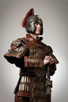 Adult male wearing very old armor.