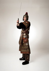 Adult male wearing very old armor.