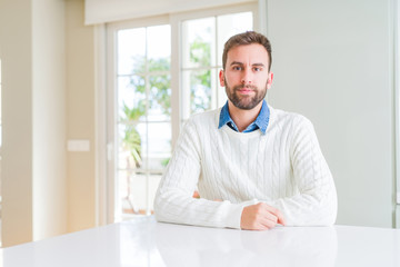 Fototapeta premium Handsome man wearing casual sweater Relaxed with serious expression on face. Simple and natural looking at the camera.