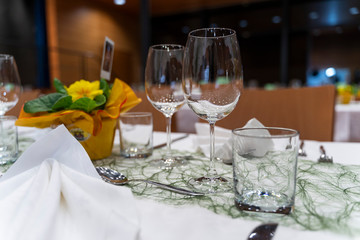 Elegant, luxury and romantic decorated dinner table with wine glasses and cutlery