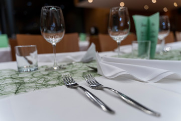 Elegant, luxury and romantic decorated dinner table with wine glasses and cutlery