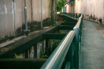 green steel walkway beside of canal