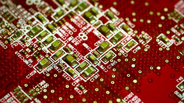 Circuit board with components in rotation. Close up of red electronic board, with components. 4K UHD Video