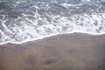 Fototapeta na wymiar Sea wave on sandy beach