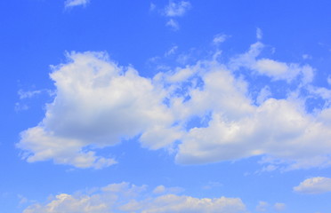 Naklejka na ściany i meble White clouds in a blue sky in a cloudy summer day