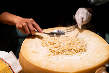 Pasta cooking in cheese bowl