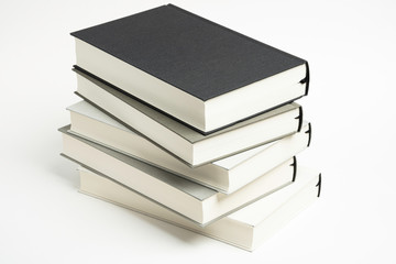 A Disarrayed Stack OF Monochromatic Cloth Bound Books Set On  White Background