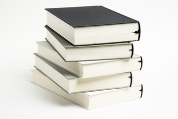 A Disarrayed Stack OF Monochromatic Cloth Bound Books Set On  White Background