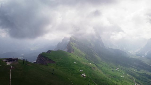 Aerial drone hyper lapse flying over Seceda Odle mountain in Dolomites Italy. Time lapse cloudscape scenary in Alps  South Tyrol.