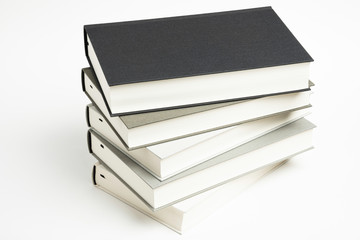 A Disarrayed Stack OF Monochromatic Cloth Bound Books Set On  White Background
