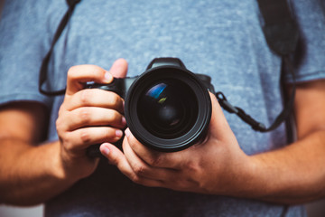 Close up of man hands holding DSLR Camera - Man photograph with camera