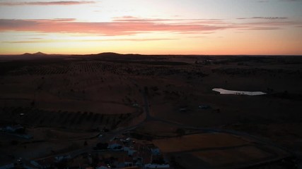 Aerial view from an amazing sunset in Alentejo, Portugal. With agricultural fields in background.