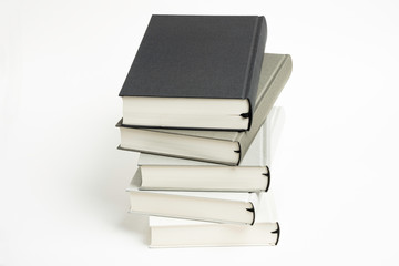 A Disarrayed Stack OF Monochromatic Cloth Bound Books Set On  White Background