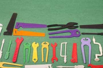 tools plastic toys on a green background