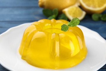 Tasty lemon jelly with mint on plate, closeup - obrazy, fototapety, plakaty