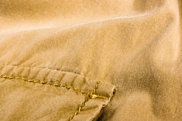 clothing items stonewashed cotton fabric texture with seams, clasps, buttons and rivets, macro