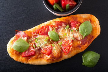 Food concept Homemade organic pizza with tomato, basil and ham with copy space