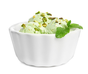 Bowl of sweet pistachio ice cream with mint on white background