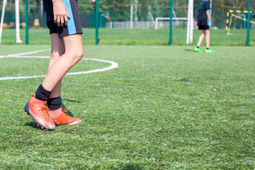 Soccer player in training. The feet of a football player. Ball game on the soccer field. Sports...