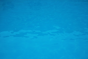 Surface of swimming pool with clean blue water as background
