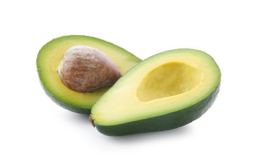 Halves of ripe avocado with pit on white background