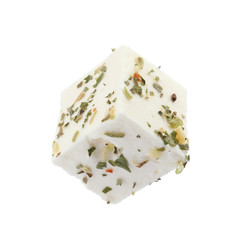 Piece of delicious feta cheese with seasoning on white background