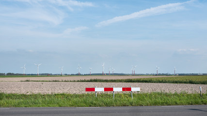 Fototapeta premium landscape with wind turbines in the dutch province of friesland under blue sky in summer
