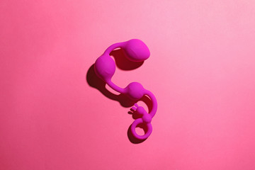 Anal balls on pink background, top view. Sex toy