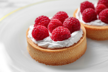 Plate with raspberry tarts, closeup. Delicious pastries