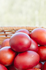 Painted eggs in onion peel lay in the wicker basket