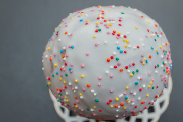 Easter spring cake in white glaze with colored sprinkles