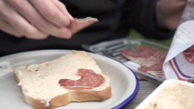 Lockdown: Putting Salami on the Bread With Spread Placed on a Plate - Smaland, Sweden
